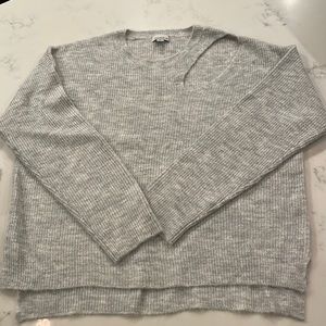Sweater with cut out detail on chest/shoulder